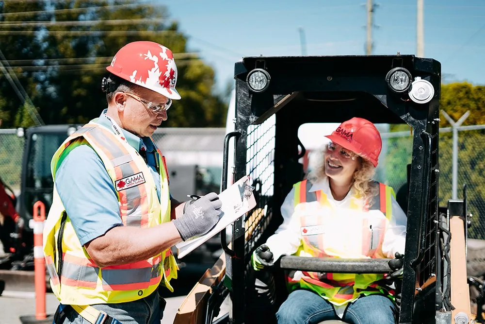 Gama Safety instructor and trainee completing a practical evaluation on a compact loader